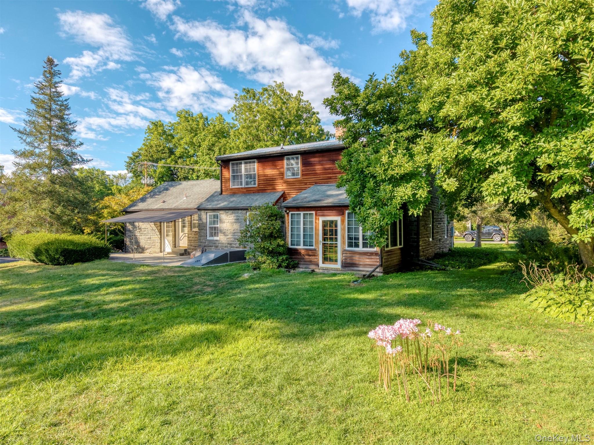 12 Zandhoek Road Hurley, NY 12443 - Photo 2 of 50 a front view of a house with a yard table and chairs