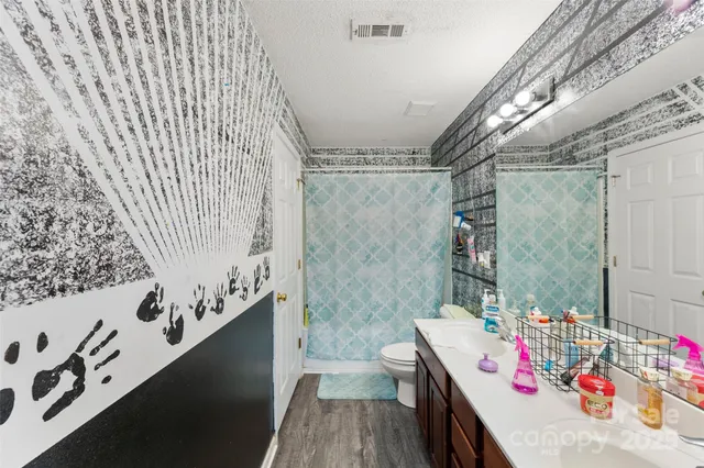 a bedroom with a bed and a potted plant