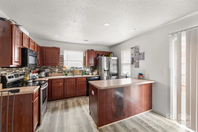 a view of a workspace with furniture and window