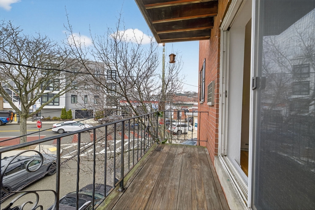 8 Kittredge Street, Unit 10 Boston, MA 02131 - Photo 12 of 16 a view of a balcony with wooden floor