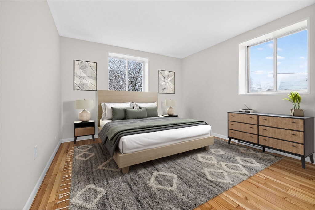 8 Kittredge Street, Unit 10 Boston, MA 02131 - Photo 5 of 16 a bedroom with a bed and a window