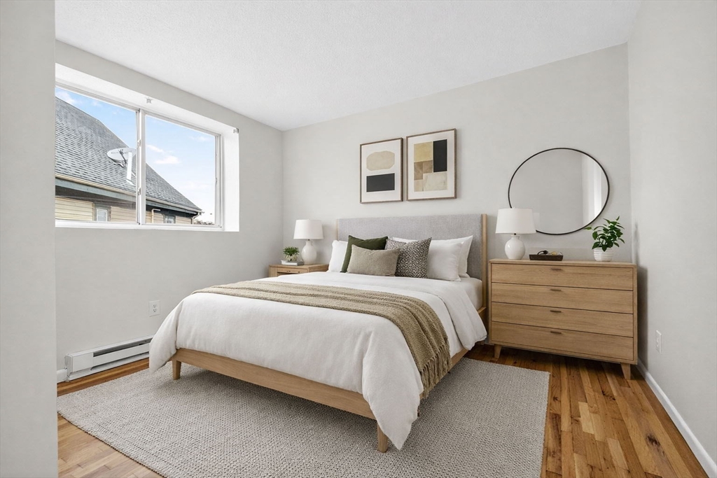 8 Kittredge Street, Unit 10 Boston, MA 02131 - Photo 6 of 16 a bedroom with a bed and window