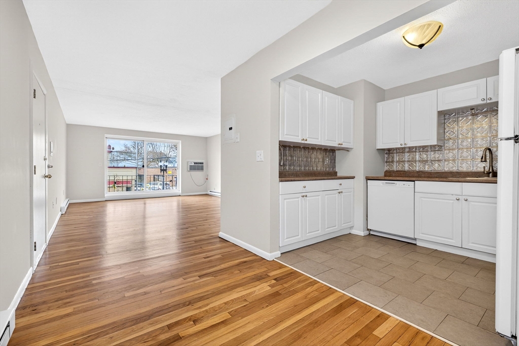 8 Kittredge Street, Unit 10 Boston, MA 02131 - Photo 8 of 16 a kitchen with granite countertop a refrigerator and a stove