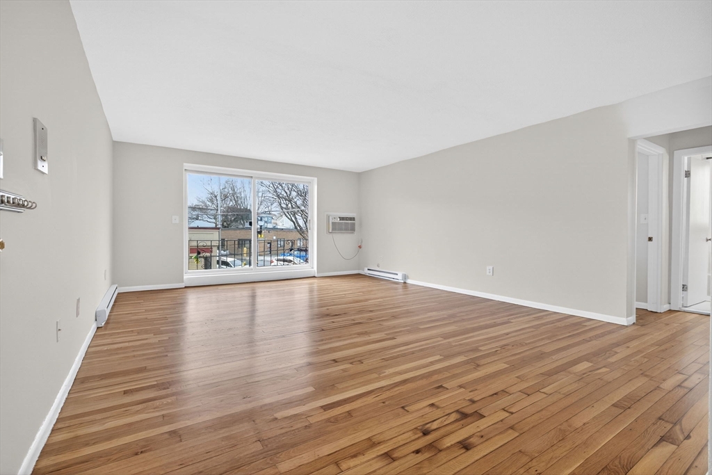 8 Kittredge Street, Unit 10 Boston, MA 02131 - Photo 9 of 16 wooden floor in an empty room with a window