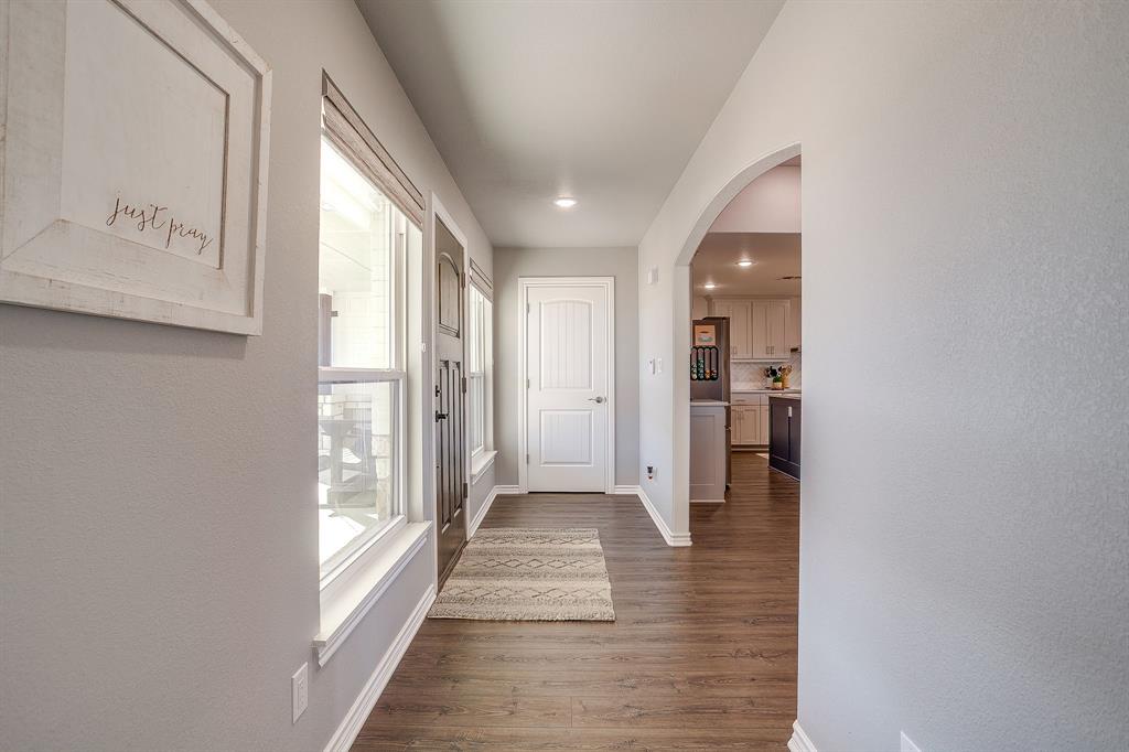 733 Fm 2652 Graham, TX 76450 - Photo 5 of 40 a view of a hallway with wooden floor and a bathroom