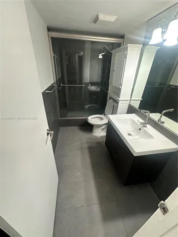 a bathroom with a sink toilet and shower
