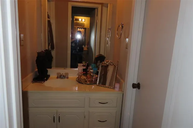 a bathroom with a sink and mirror