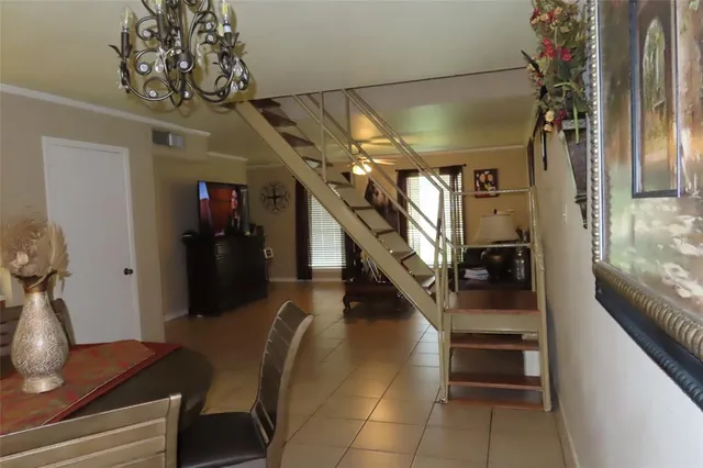 a hallway with dining room and stairs