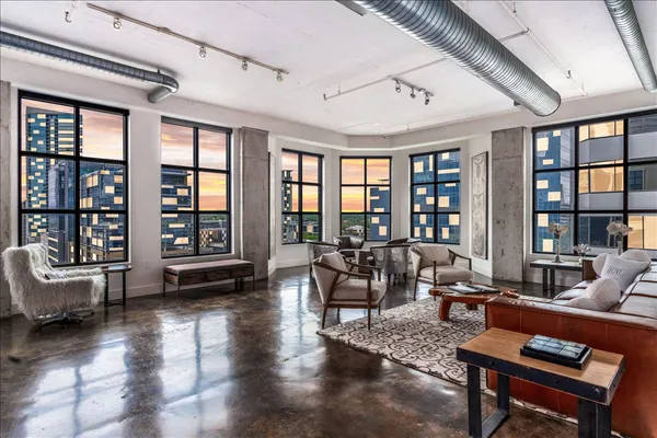 a living room with furniture and a large window