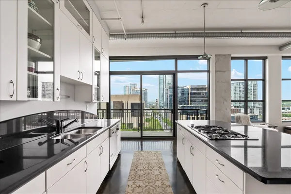a very nice looking living room with furniture and floor to ceiling windows