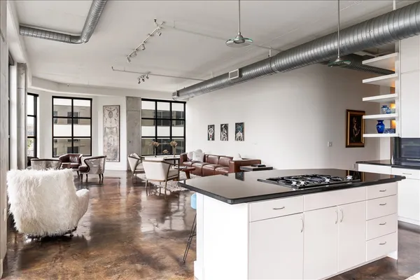 a kitchen with stainless steel appliances a sink stove and cabinets
