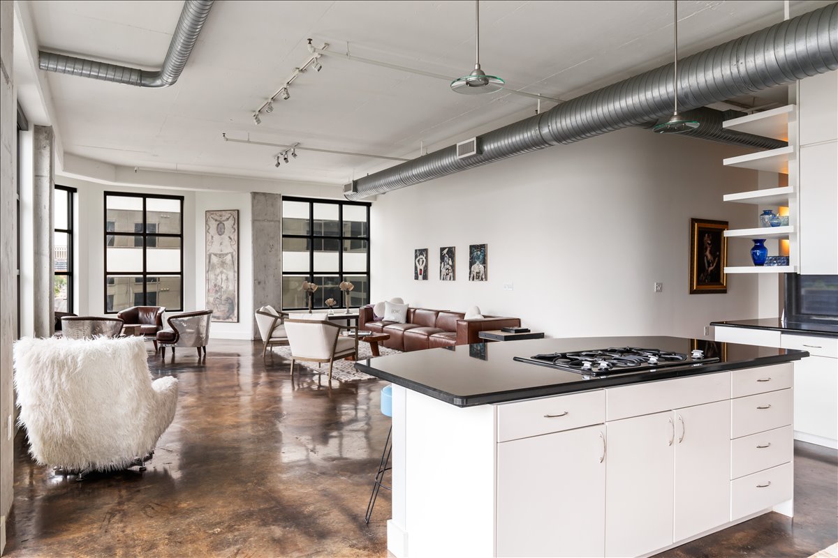 311 West 5th Street, Unit 1005 Austin, TX 78701 - Photo 11 of 30 The kitchen opens gracefully to sweeping views of the expansive living area, where the seamless flow between spaces enhances natural light, elevates the sense of openness, and creates an elegant setting designed for both refined entertaining and effortless everyday living.