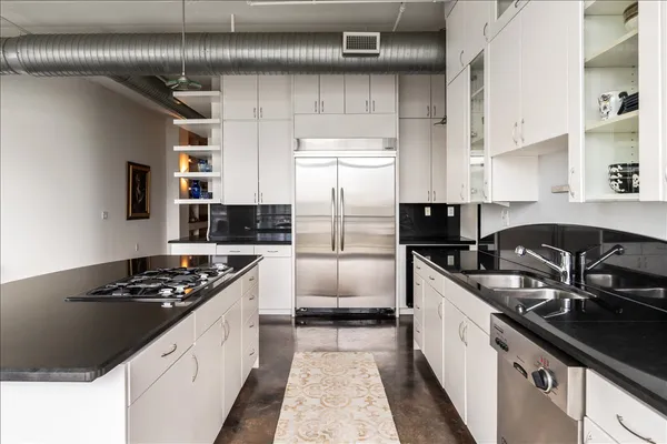 a kitchen with cabinets and stainless steel appliances