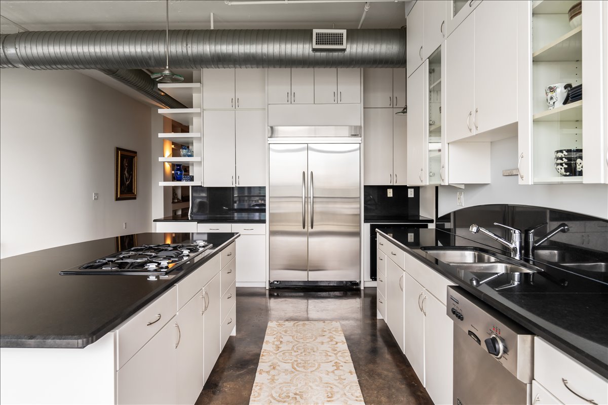 311 West 5th Street, Unit 1005 Austin, TX 78701 - Photo 13 of 30 These high-end appliances pair beautifully with luxurious stone countertops, where sleek surfaces, sophisticated finishes, and thoughtful details create an elegant culinary space designed for both everyday living and elevated entertaining.