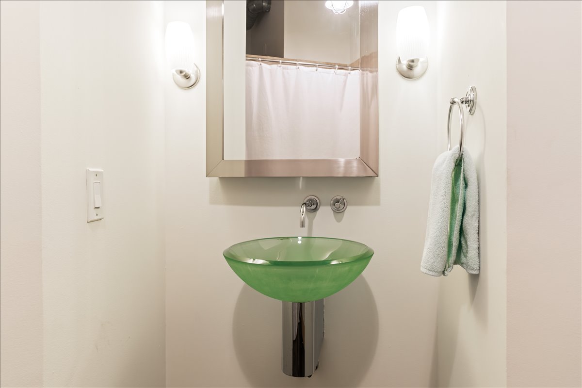 311 West 5th Street, Unit 1005 Austin, TX 78701 - Photo 22 of 30 This modern bathroom retreat has a glass pedestal sink and a luminous, open feel.