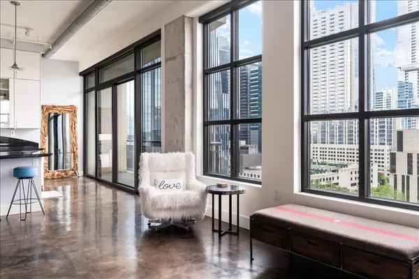 a living room with furniture and floor to ceiling windows