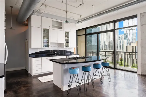 a kitchen with a table chairs refrigerator and cabinets