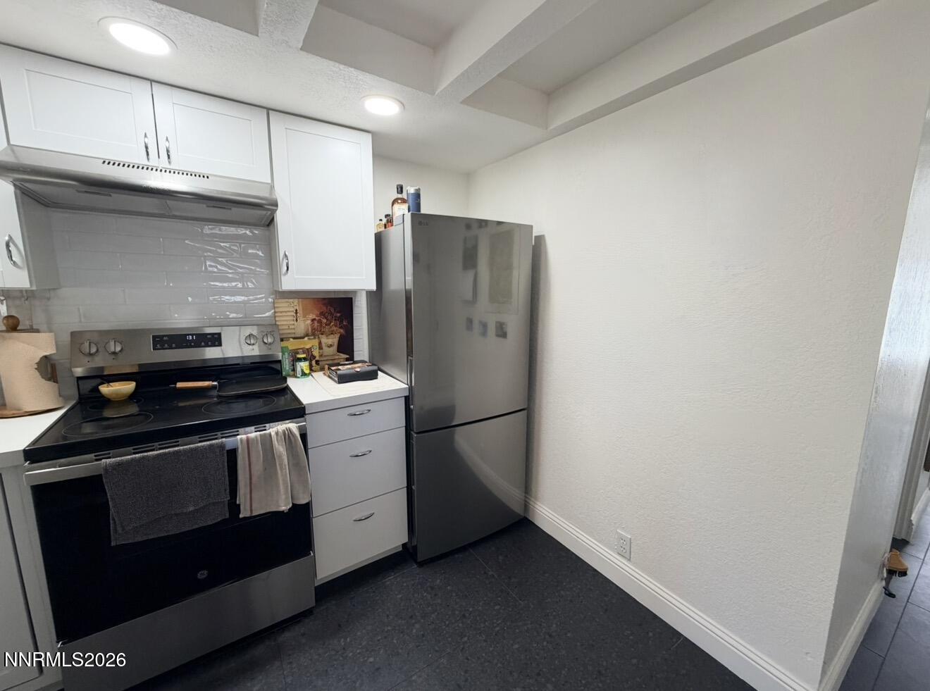 16770 Mt Rose Highway, Unit B Reno, NV 89511 - Photo 11 of 26 a white refrigerator freezer sitting inside of a kitchen