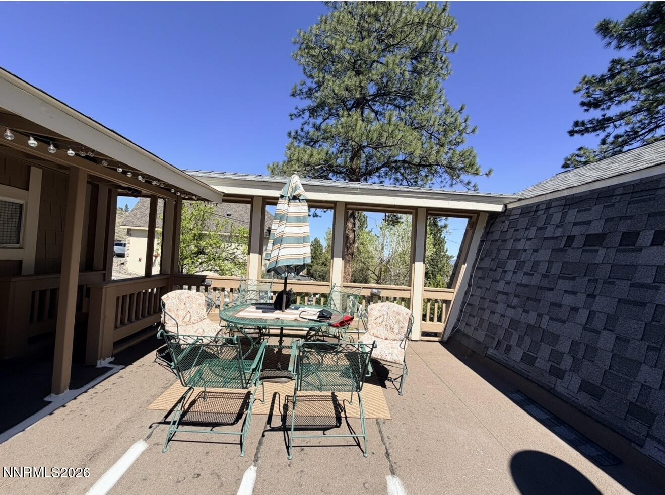 16770 Mt Rose Highway, Unit B Reno, NV 89511 - Photo 3 of 26 a roof deck with table and chairs and potted plants