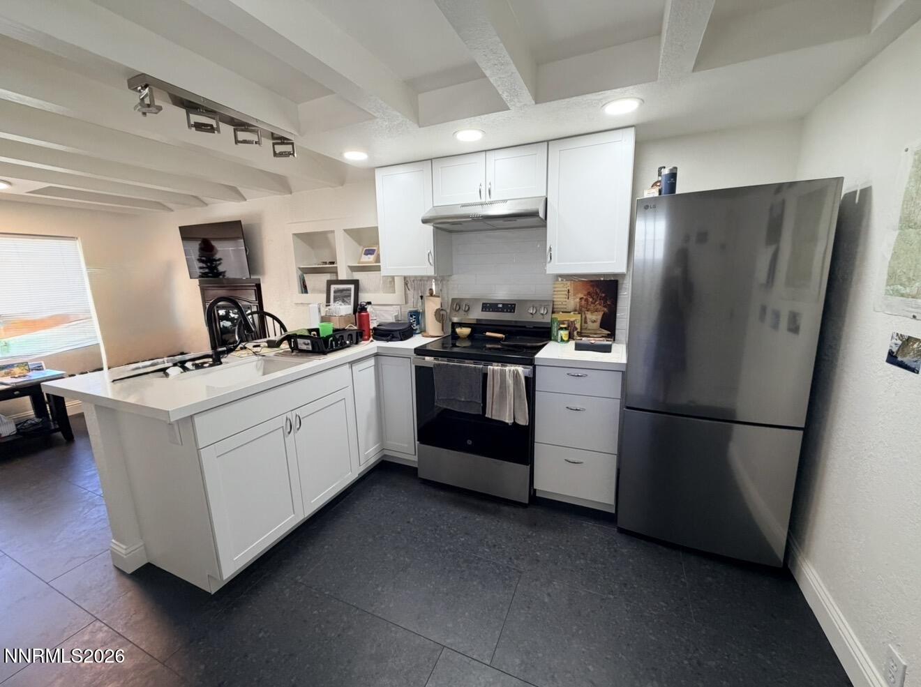16770 Mt Rose Highway, Unit B Reno, NV 89511 - Photo 7 of 26 a kitchen with white cabinets and white appliances