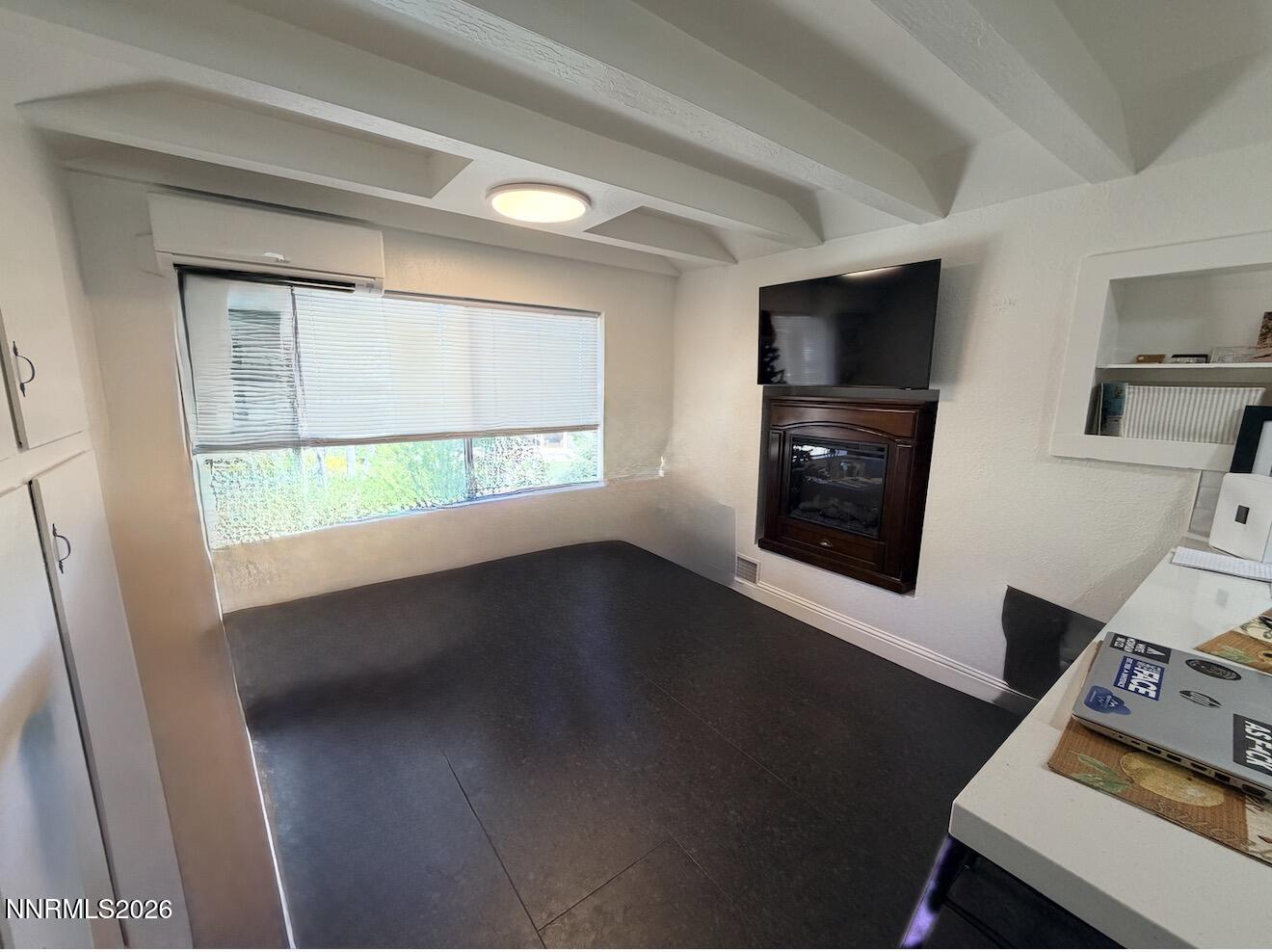 16770 Mt Rose Highway, Unit B Reno, NV 89511 - Photo 10 of 26 a view of an empty room with a window and wooden floor