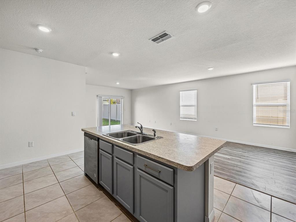 4223 San Rocco Way Winter Haven, FL 33884 - Photo 11 of 47 a kitchen with a sink and cabinets
