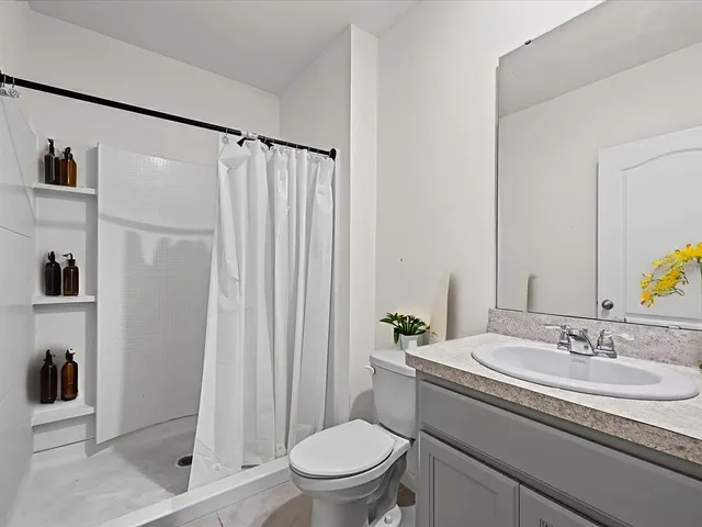 a bathroom with a sink toilet and shower