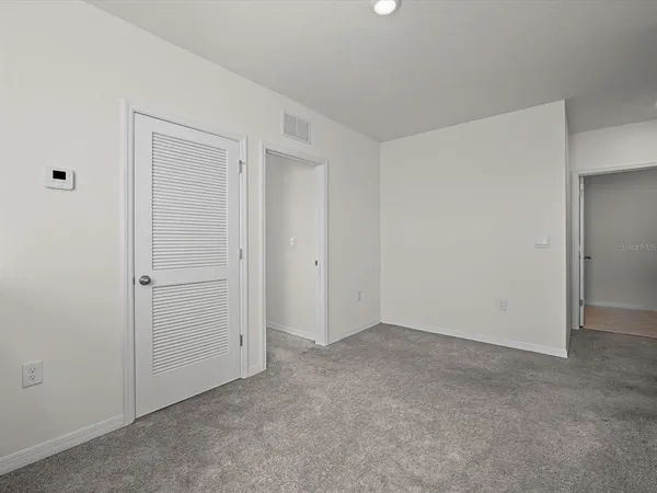 an empty room with closet area