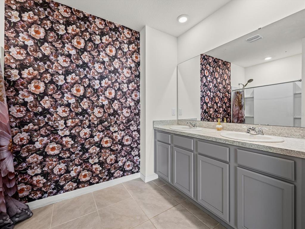 4223 San Rocco Way Winter Haven, FL 33884 - Photo 25 of 47 a bathroom with a sink and a mirror