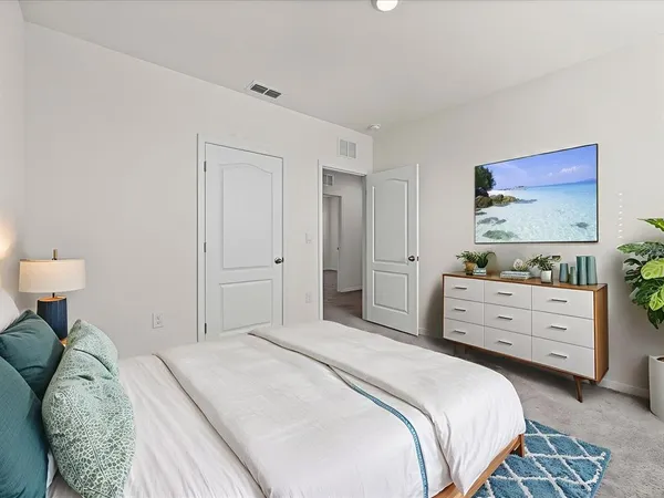 a bedroom with a bed and a dresser