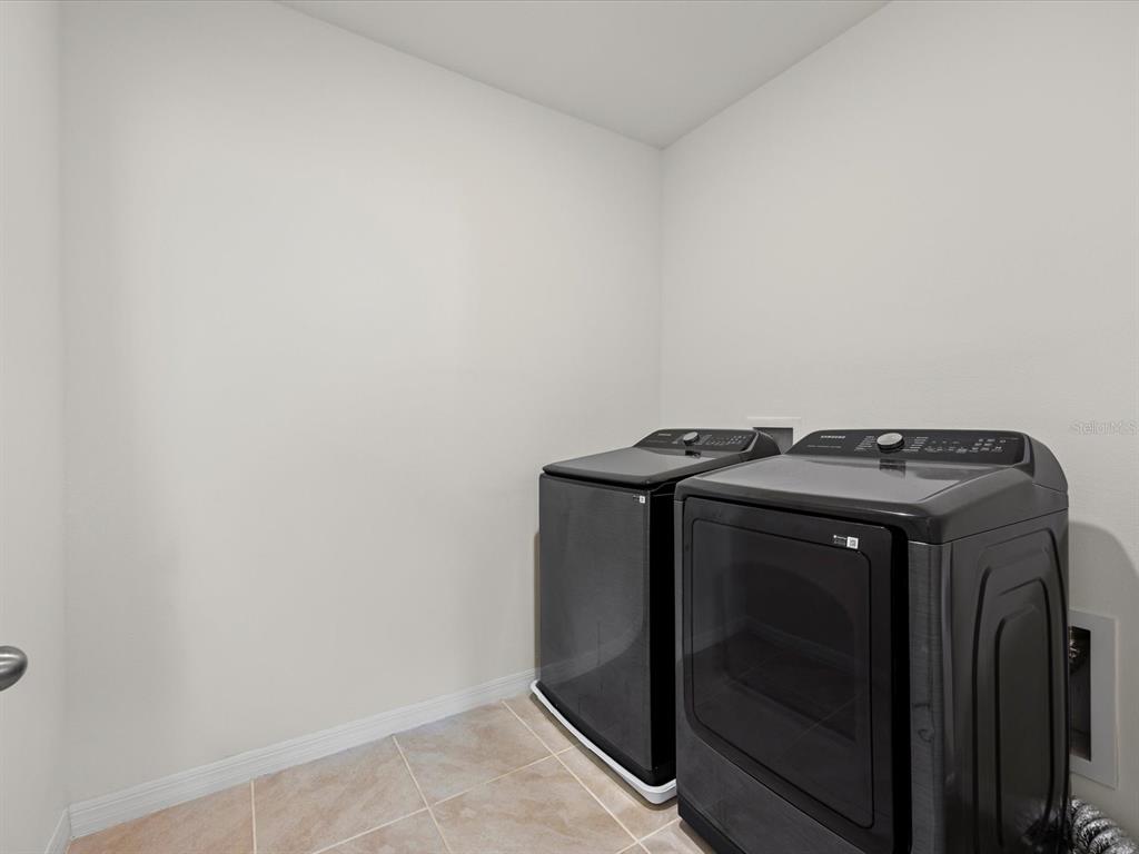 4223 San Rocco Way Winter Haven, FL 33884 - Photo 35 of 47 a utility room with dryer and washer