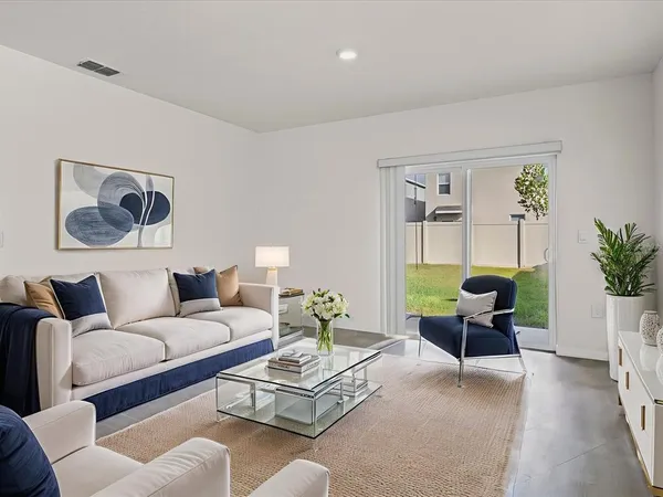 a living room with furniture and a potted plant