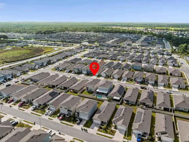 an aerial view of residential building with outdoor space and ocean view