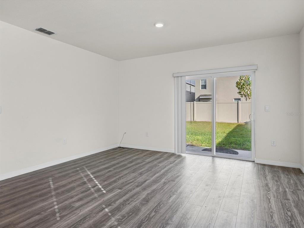 4223 San Rocco Way Winter Haven, FL 33884 - Photo 5 of 47 wooden floor in an empty room with a window