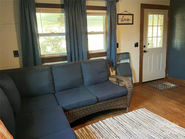 a kitchen with stainless steel appliances granite countertop a refrigerator a stove and a sink with wooden floor