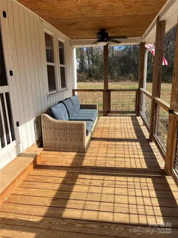 a bedroom with a bed a flat screen tv and balcony
