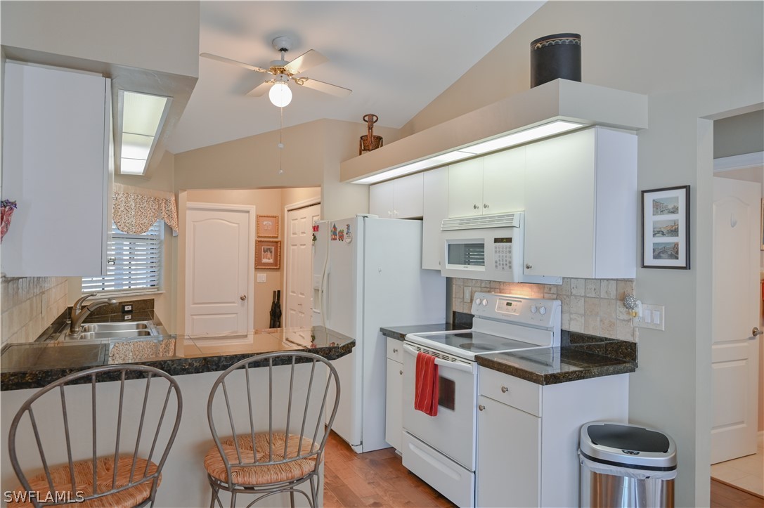 9092 Morris Road Fort Myers, FL 33967 - Photo 11 of 28 a kitchen that has a cabinets and a stove top oven