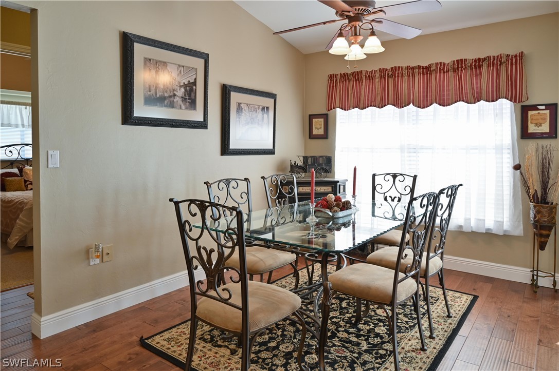 9092 Morris Road Fort Myers, FL 33967 - Photo 8 of 28 a dining room with furniture a chandelier and wooden floor