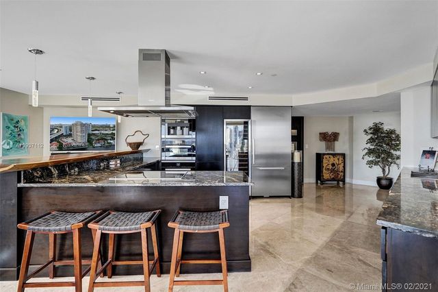 a kitchen with a stove a microwave and cabinets