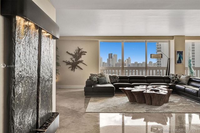 a living room with furniture a flat screen tv and a large window