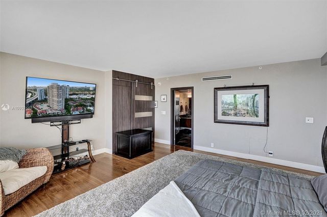 a bed room with a bed and a television