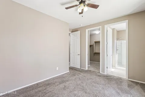 a front view of a house with a yard and potted plants