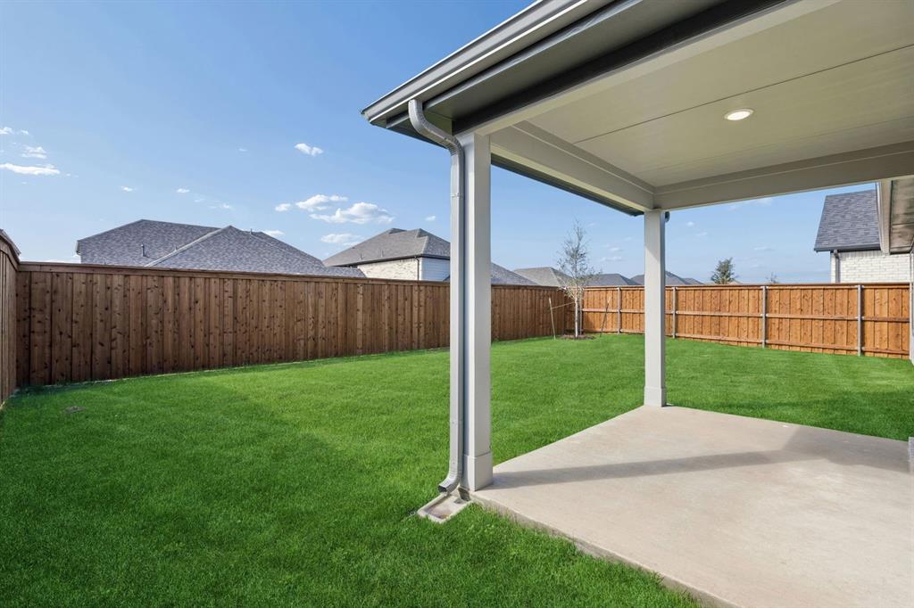 1456 Companero Street Haslet, TX 76052 - Photo 29 of 33 a view of a backyard with wooden fence