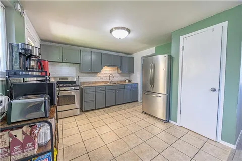 a kitchen with stainless steel appliances granite countertop a refrigerator sink and stove
