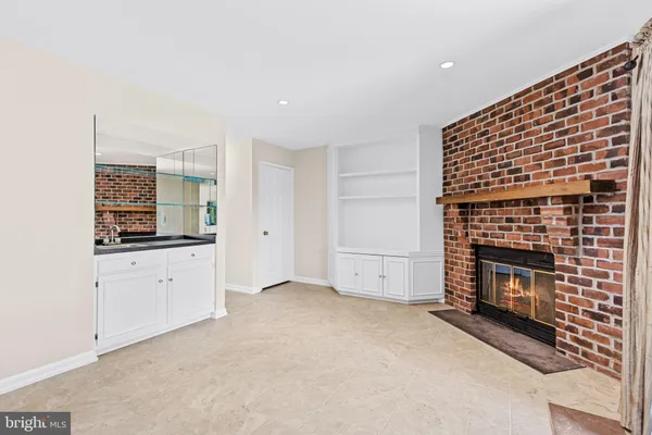 a view of empty room with a fireplace and cabinet