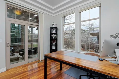 a view of a workspace with furniture and a window