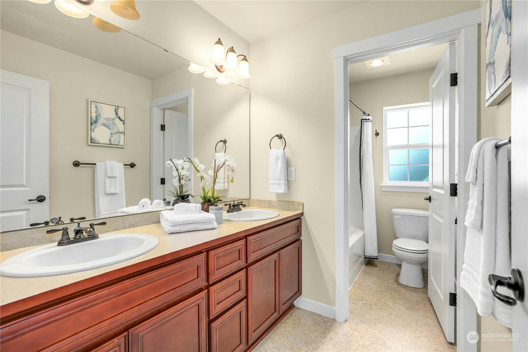 5214 Northeast 7th Street Renton, WA 98059 - Photo 16 of 20 a spacious bathroom with a double vanity sink toilet and a mirror