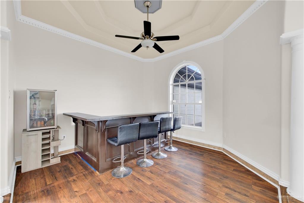 3517 Princess Street Edinburg, TX 78539 - Photo 12 of 22 a workspace room with wooden floor a chandelier fan and windows