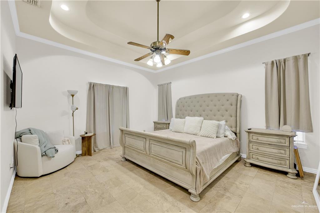 3517 Princess Street Edinburg, TX 78539 - Photo 14 of 22 a bedroom with a bed and a chandelier