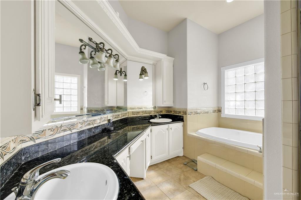 3517 Princess Street Edinburg, TX 78539 - Photo 15 of 22 a bathroom with a granite countertop sink and a bathtub